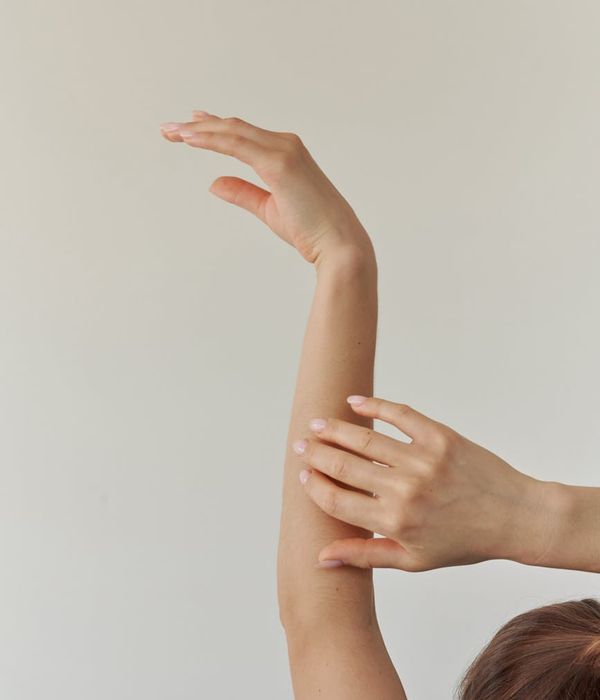 Woman in a graceful yoga pose with aquamarine light accents.